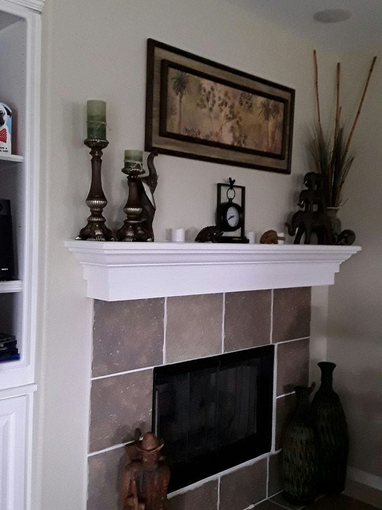 Living room wall painted a soft neutral with a crisp white fireplace mantel